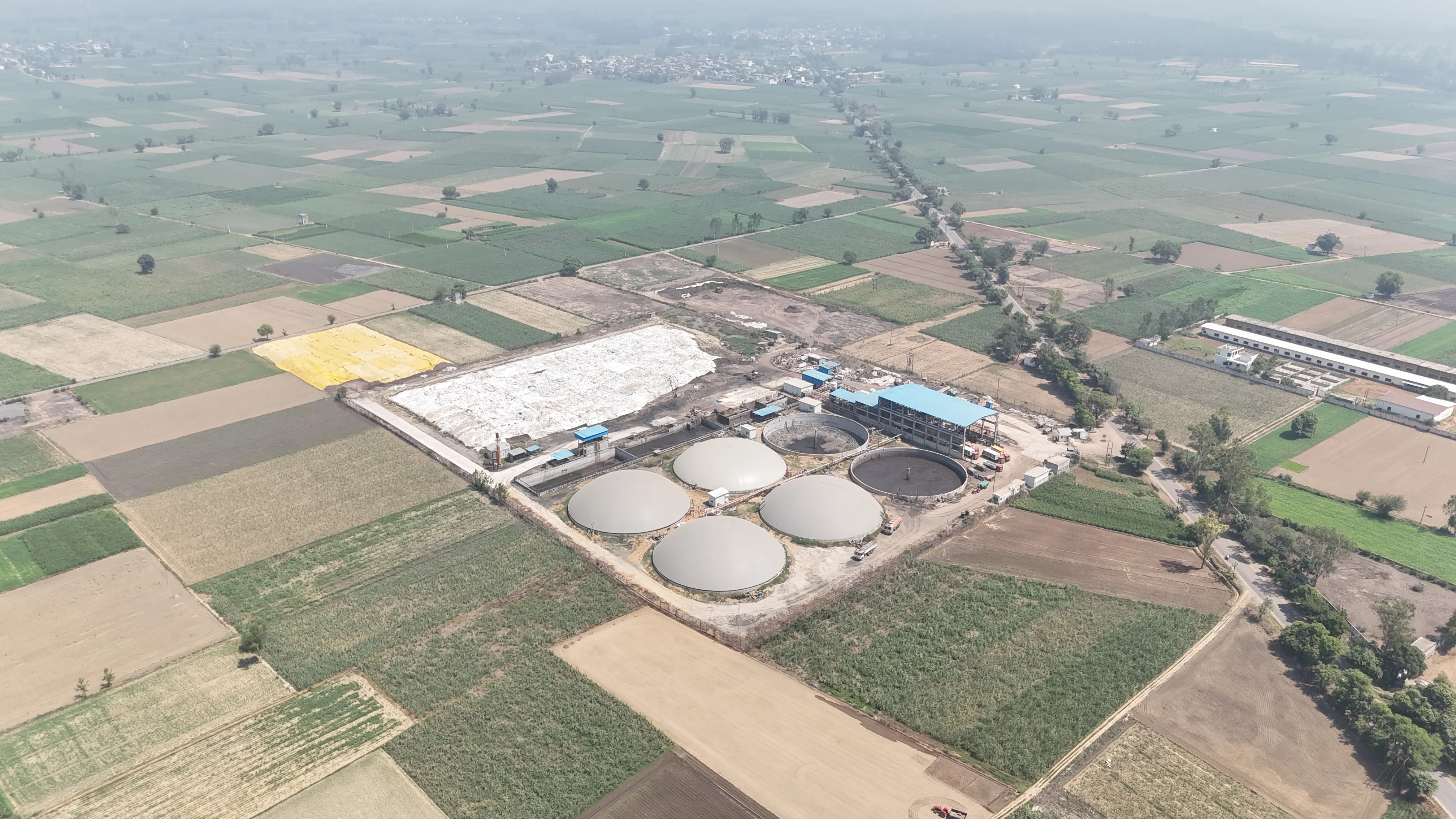 Wide oblique aerial of the Circle CBG Meerut plant among farmland